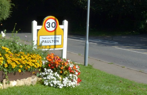Other side of gateway sign for drivers leaving the village